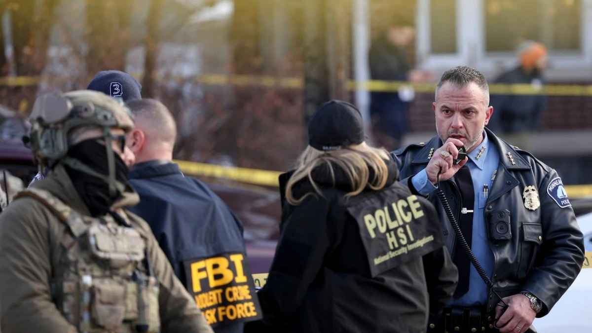 “Federal agent at Minneapolis shooting scene near 26th Street West and Nicollet Avenue”