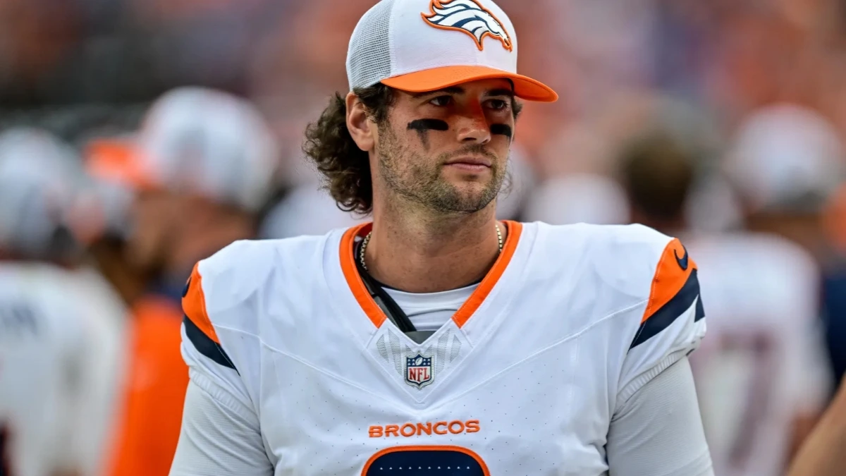Jarrett Stidham, Denver Broncos quarterback, walking onto the field wearing a cowboy hat before the AFC Championship Game against the New England Patriots