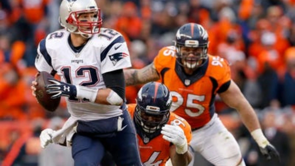 Denver Broncos quarterback Jarrett Stidham throws a pass under pressure against the New England Patriots during the AFC Championship game at Empower Field at Mile High.