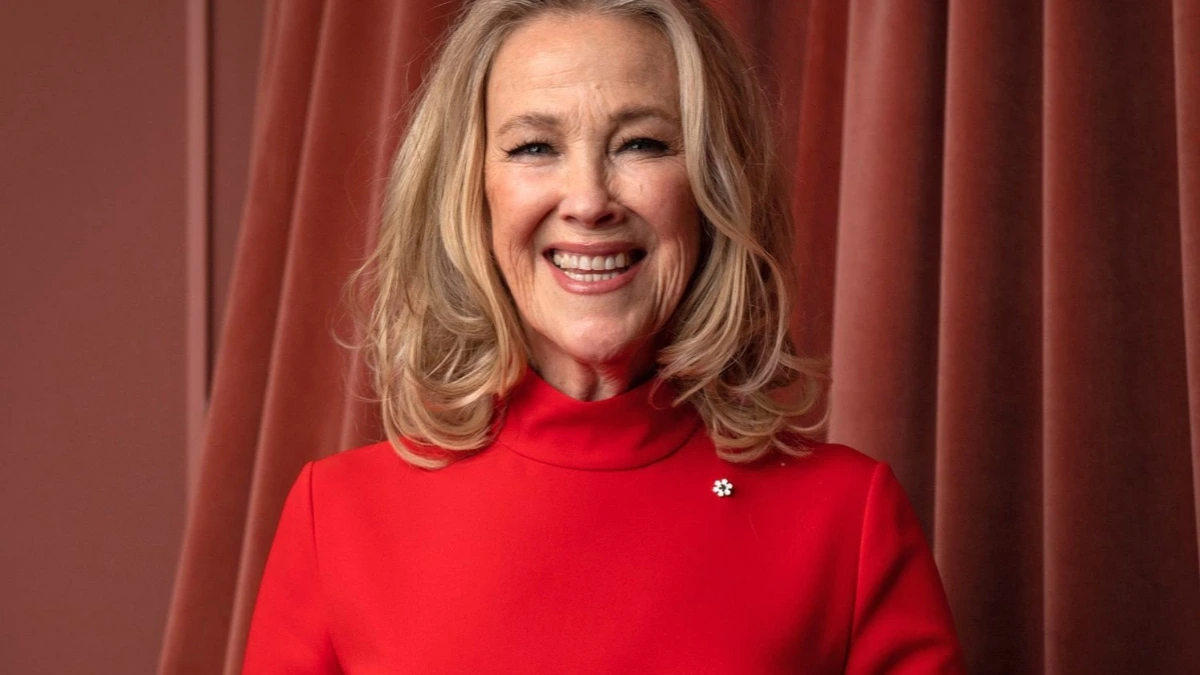 Catherine O’Hara smiling on a red carpet event, wearing a black dress, 2025.