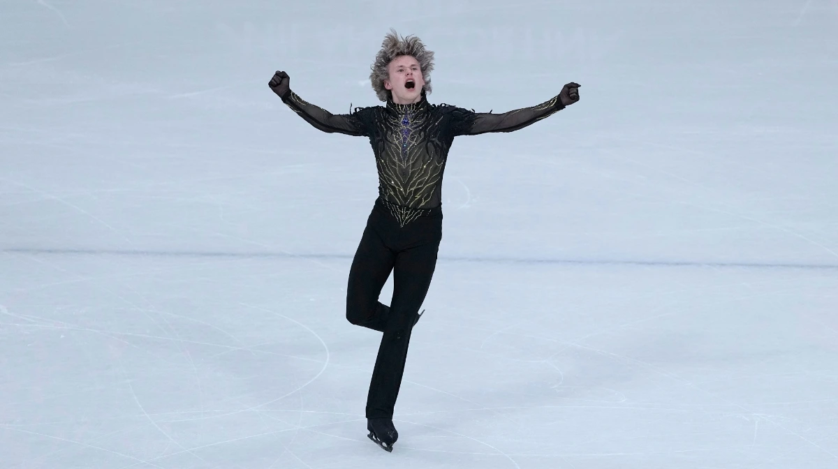Ilia Malinin reacts after falling during the men’s free skate at the Milano Cortina Winter Olympics as Mikhail Shaidorov skates to gold.