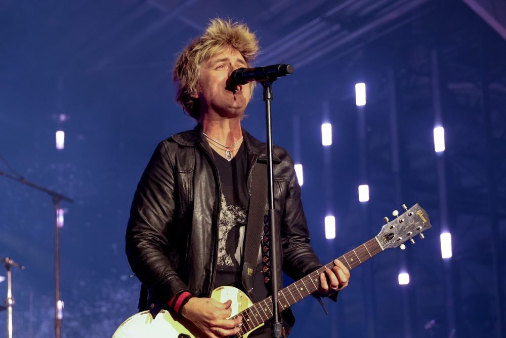 Billie Joe Armstrong performing at pre-Super Bowl concert, addressing ICE agents and urging them to quit their jobs.