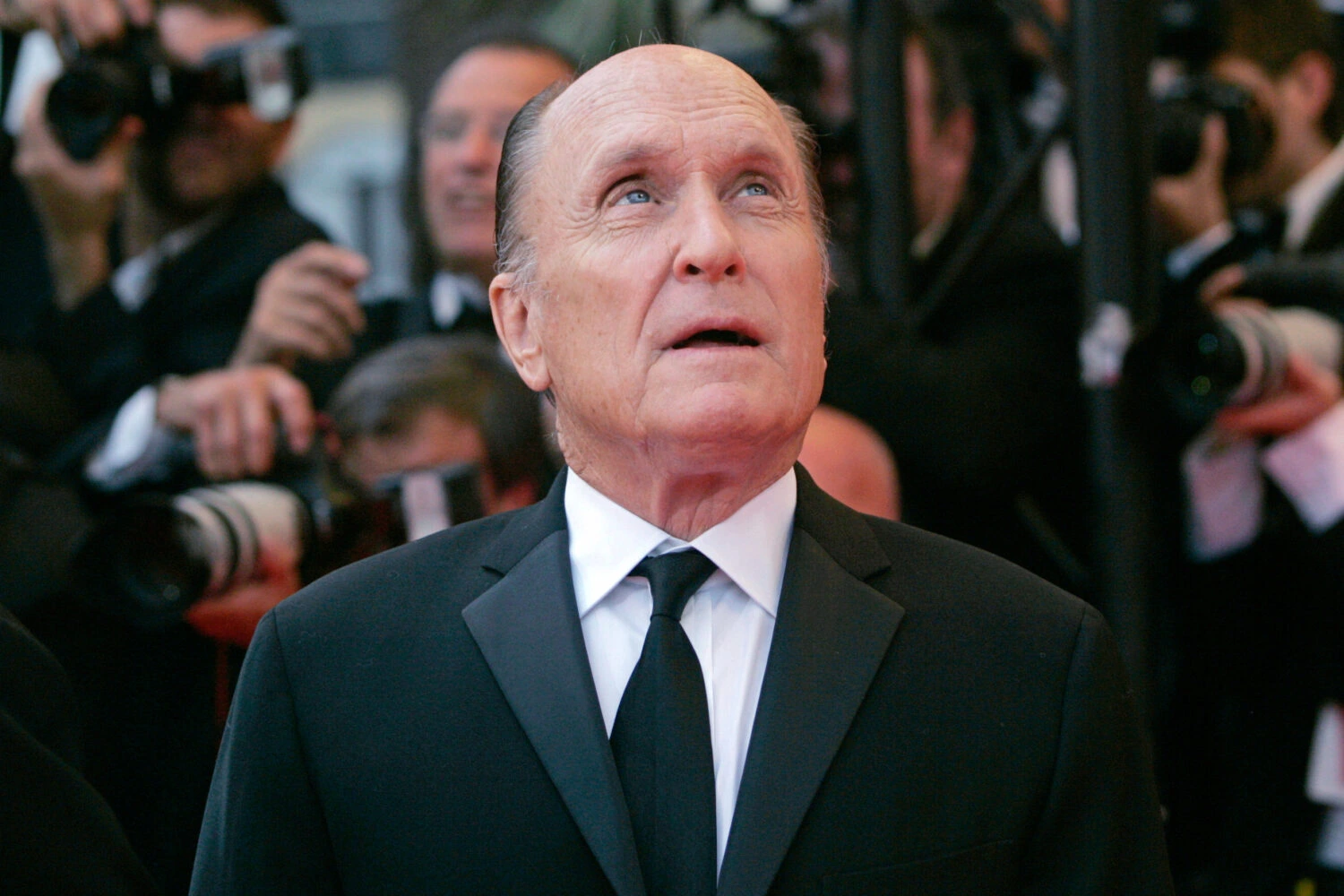 Robert Duvall attends a film premiere, smiling softly, reflecting on his decades-long Hollywood career.