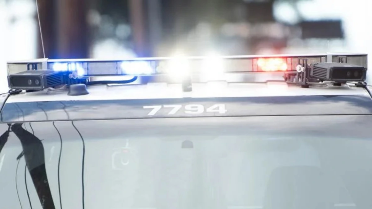 Austin Police SWAT team outside a residential building in West University neighborhood during a barricaded subject response, with tactical vehicles and officers on scene.