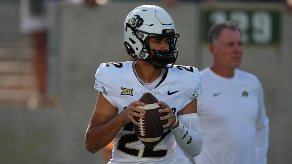 Dominiq Ponder, Colorado Buffaloes quarterback, stands on the field in uniform before an early morning game.