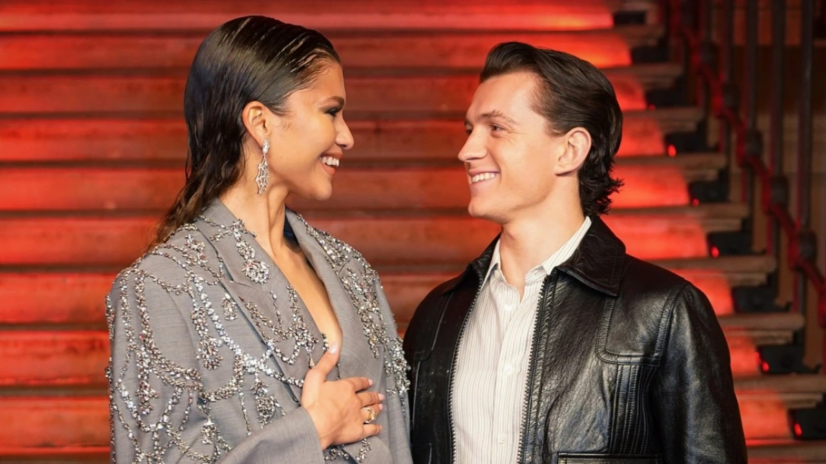 Zendaya and Tom Holland walking the red carpet, Zendaya wearing a gold ring, hinting at a private wedding