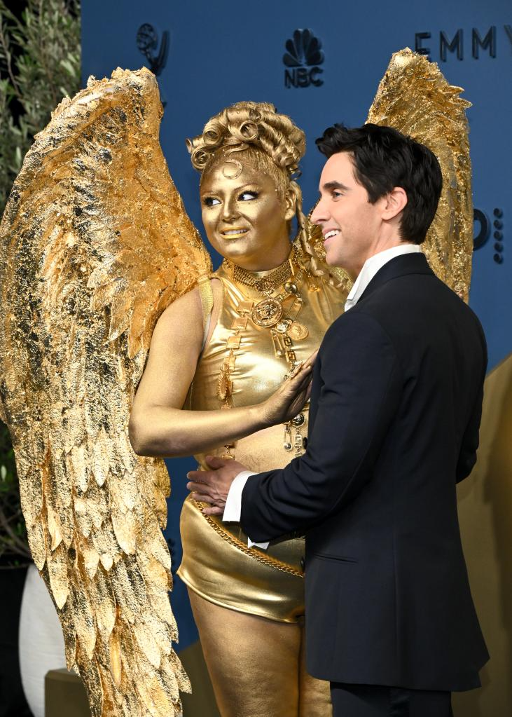 Meg Stalter 2026 Emmys red carpet wearing a gold Emmy-inspired outfit