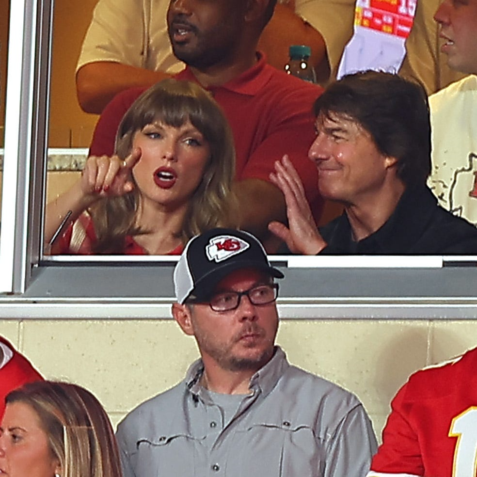 Taylor Swift and Tom Cruise talking during the Chiefs game at Arrowhead Stadium in 2026