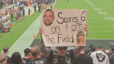 Raiders fan holds Taylor Swift sign during Chiefs game at Allegiant Stadium