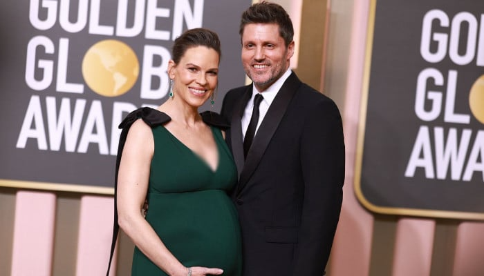 Hilary Swank pregnant with her third child at 52 with husband Philip Schneider and their growing family.