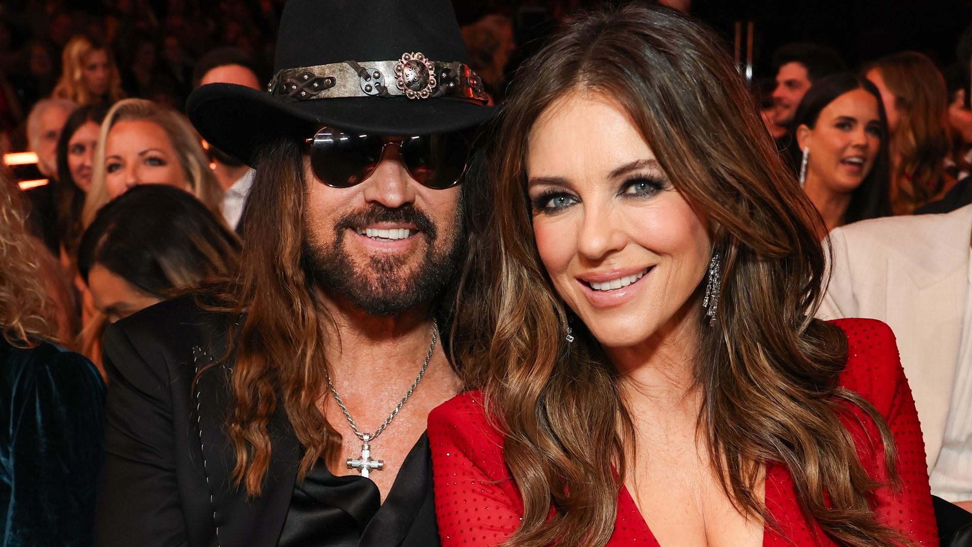 Billy Ray Cyrus and Elizabeth Hurley reportedly engaged after more than a year of dating, with Hurley spotted wearing a large diamond ring.