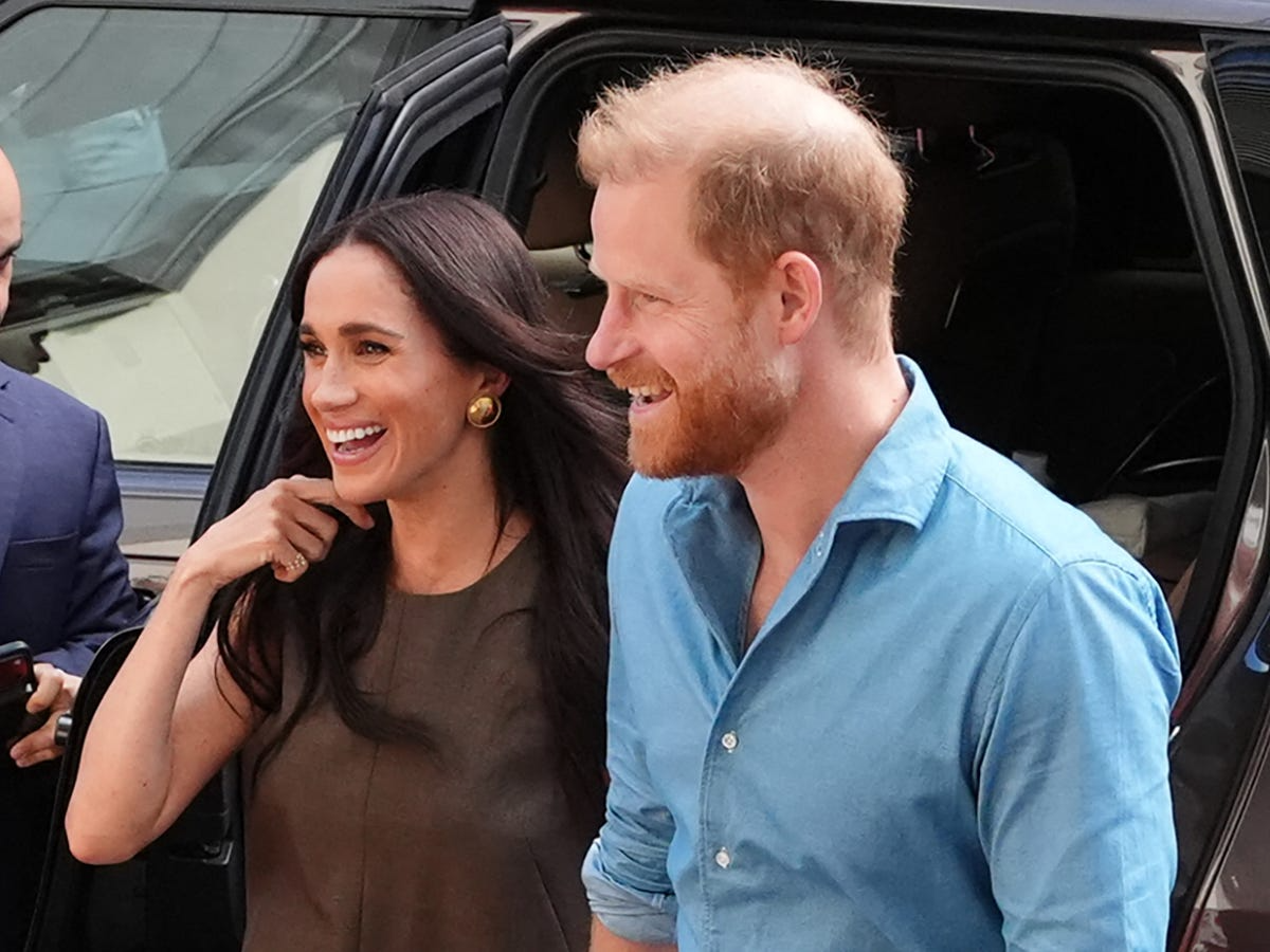 Meghan Markle and Prince Harry hold hands during a rare pub date in Great Tew, Oxfordshire